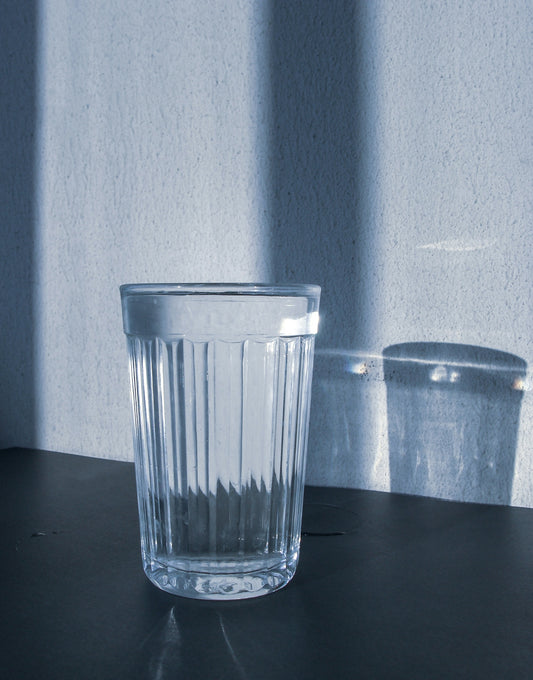 clear drinking glass on black surface