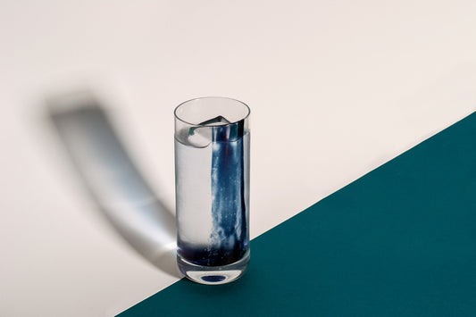 a blue and white vase sitting on top of a table